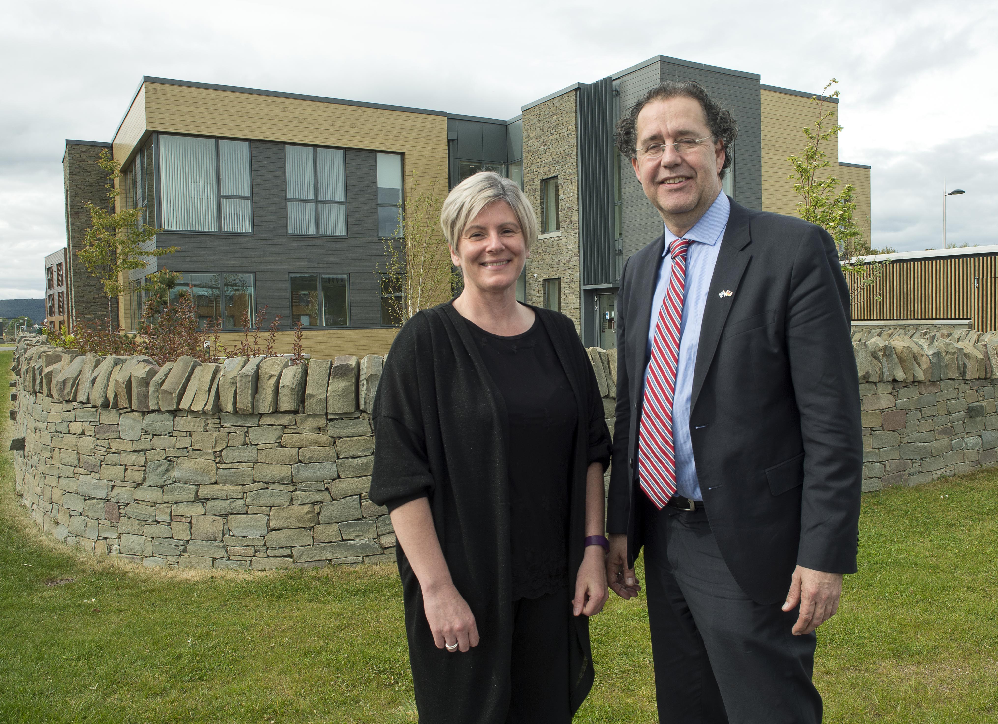 Lesley Patience and Dr Cornelius Glissman of CorporateHealth International standing outside Aurora House on Inverness Campus